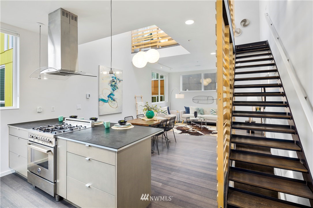 1623 14th Avenue, Unit E Seattle, WA 98122 - Photo 20 of 40 a kitchen with a stove and a wooden floor