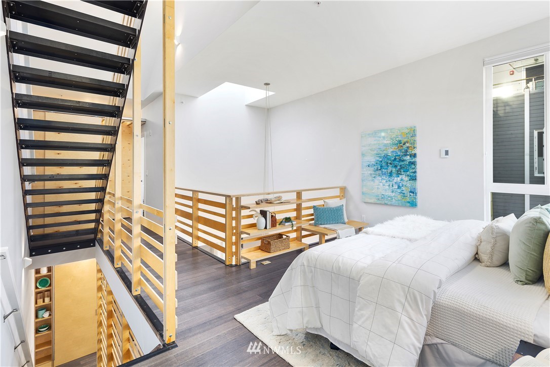 1623 14th Avenue, Unit E Seattle, WA 98122 - Photo 21 of 40 a bedroom with a bed and a window