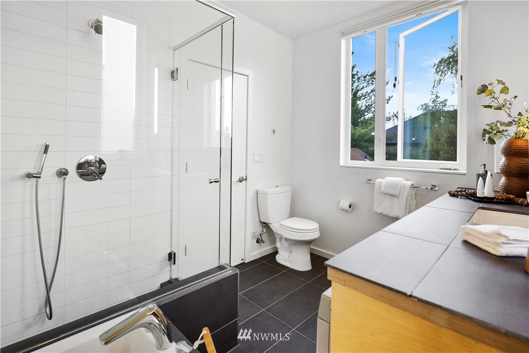 1623 14th Avenue, Unit E Seattle, WA 98122 - Photo 28 of 40 a bathroom with a sink and a mirror
