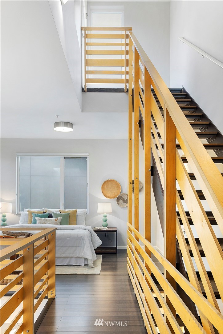 1623 14th Avenue, Unit E Seattle, WA 98122 - Photo 29 of 40 a bedroom with a bed and a chandelier