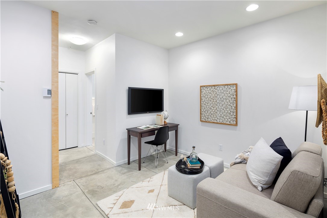 1623 14th Avenue, Unit E Seattle, WA 98122 - Photo 5 of 40 a living room with furniture and a flat screen tv
