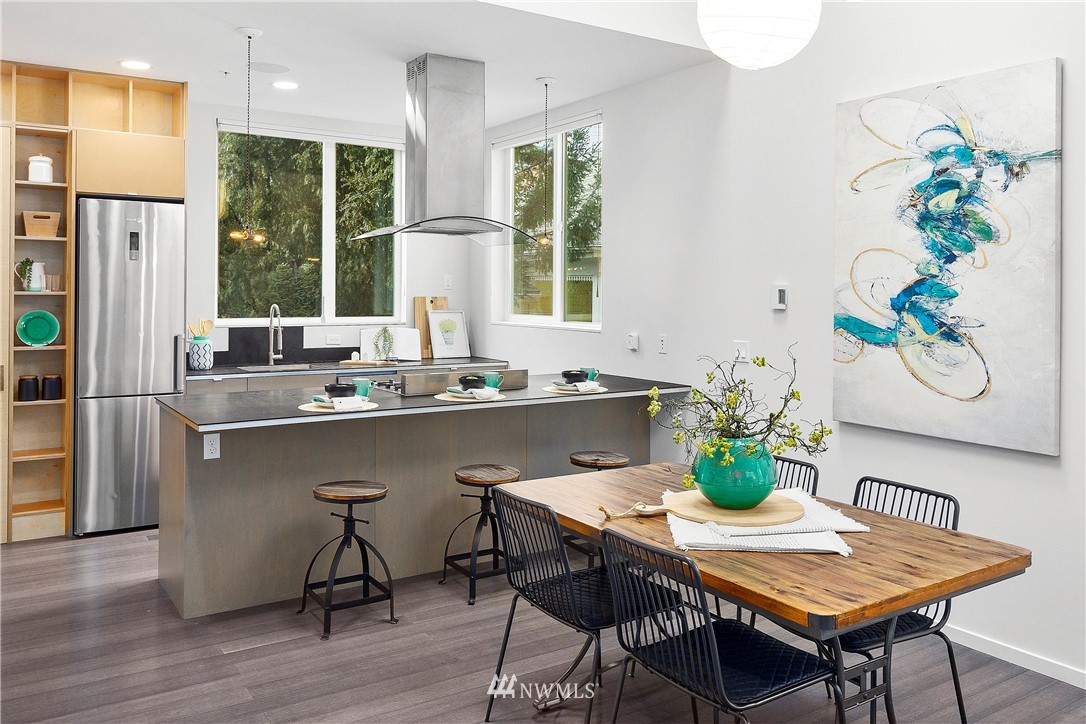1623 14th Avenue, Unit E Seattle, WA 98122 - Photo 10 of 40 a dining room with furniture a potted plant and wooden floor