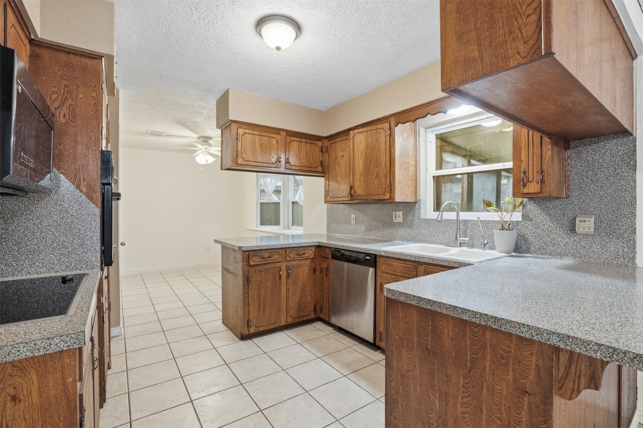 2605 Burke Road Pasadena, TX 77502 - Photo 4 of 29 a kitchen with stainless steel appliances granite countertop a sink and a stove