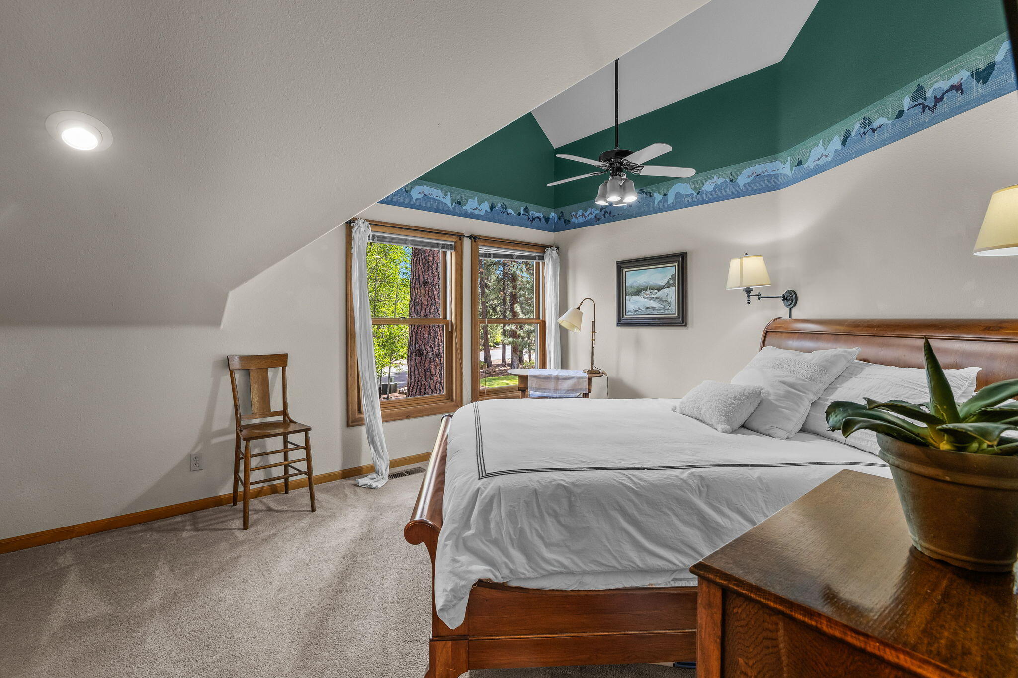 60779 Currant Way Bend, OR 97702 - Photo 40 of 63 a bedroom with a bed table flowerpot and window