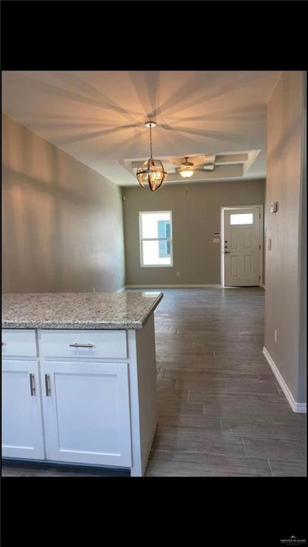 2104 Stauffers Street Weslaco, TX 78596 - Photo 5 of 12 Unfurnished dining area featuring baseboards and wood tiled floors