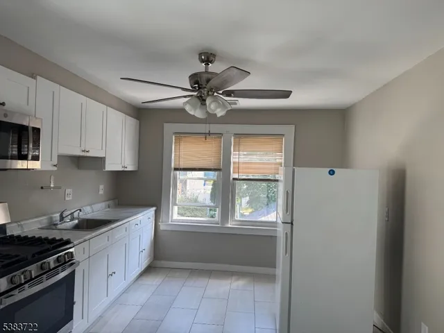a kitchen with a stove a sink and a window