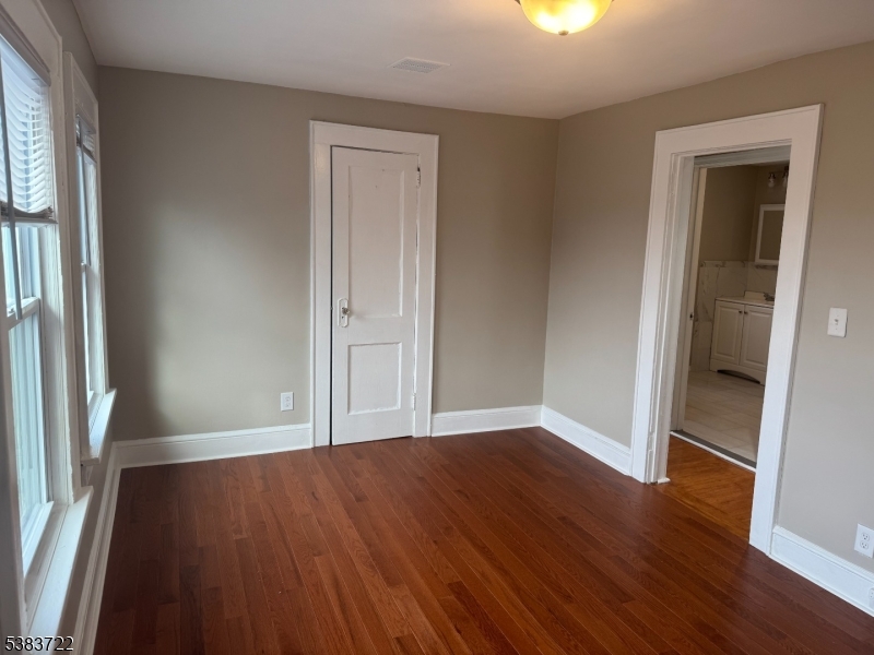 375 Tower Street Union, NJ 07088 - Photo 10 of 11 an empty room with wooden floor and windows