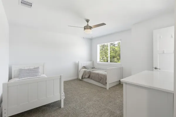 a bedroom with a bed and a window