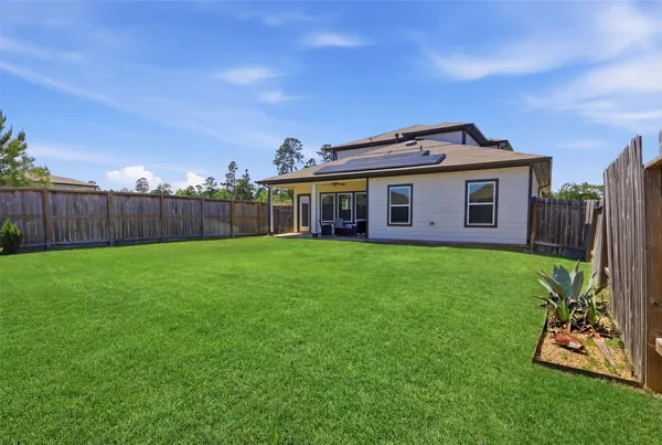 a view of a house with a yard and plants