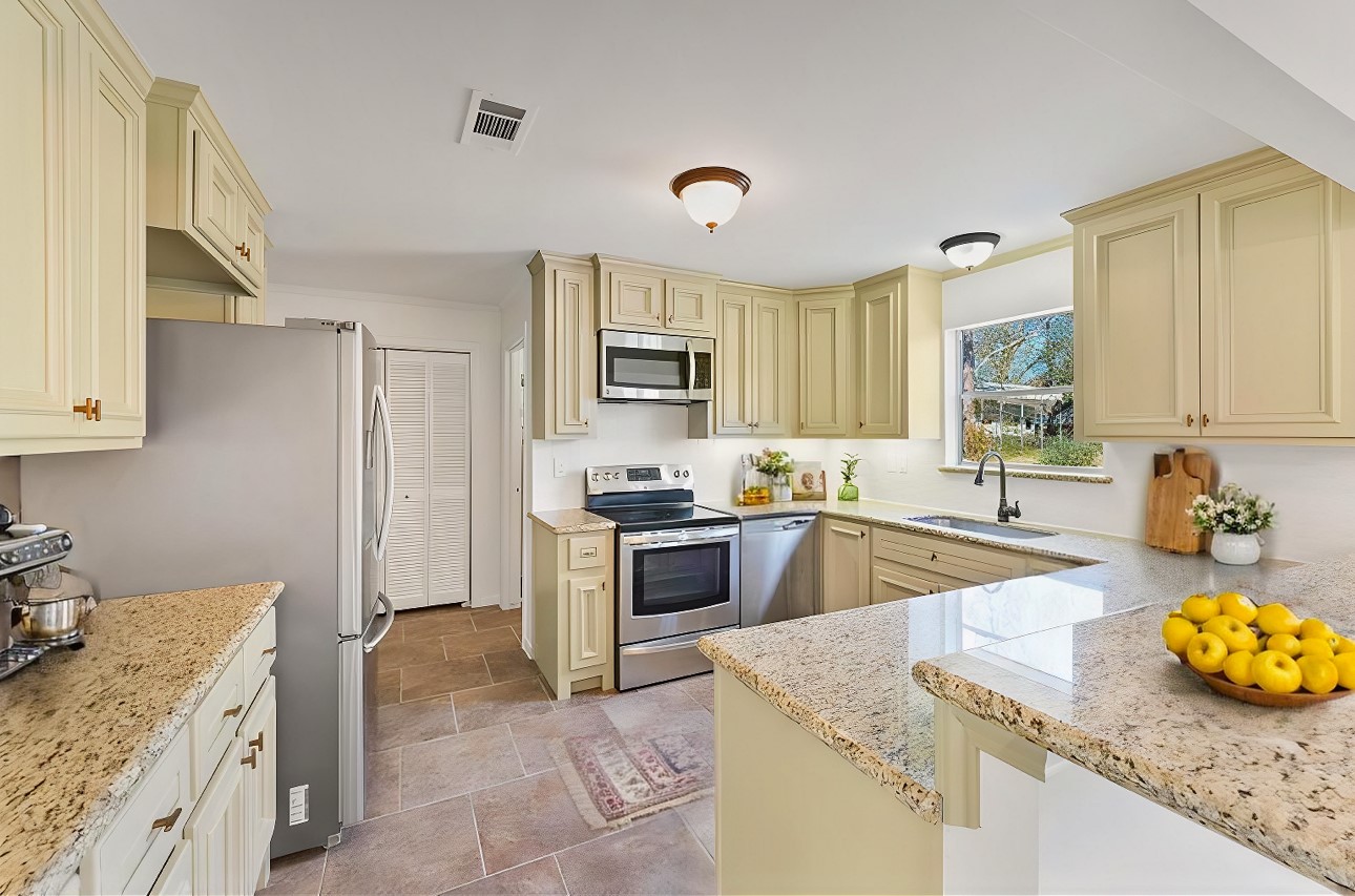 22514 Lakeway Drive Spring, TX 77373 - Photo 12 of 18 a kitchen with a stove a sink and a microwave
