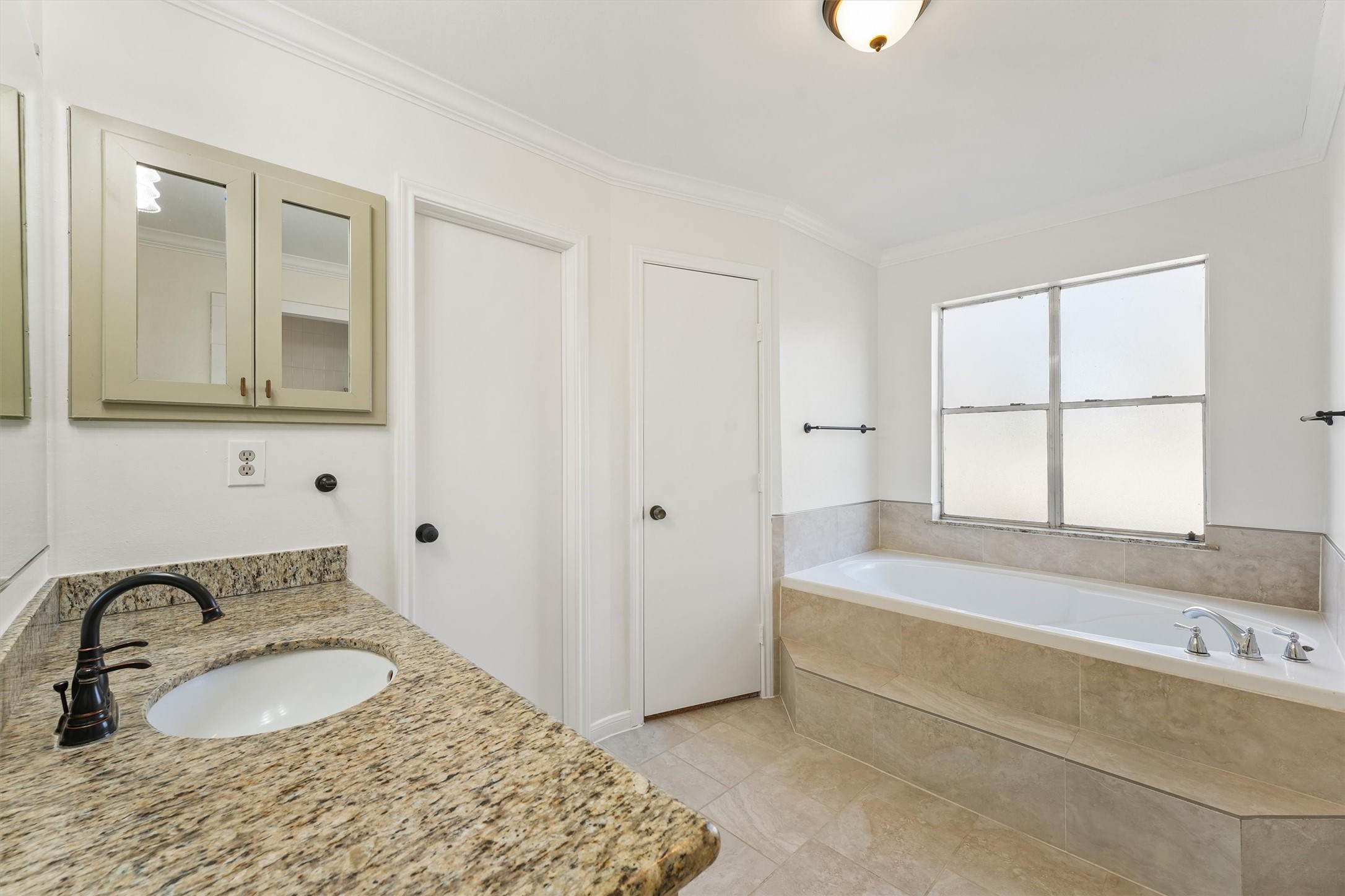 22514 Lakeway Drive Spring, TX 77373 - Photo 15 of 18 a bathroom with a granite countertop sink and a bathtub