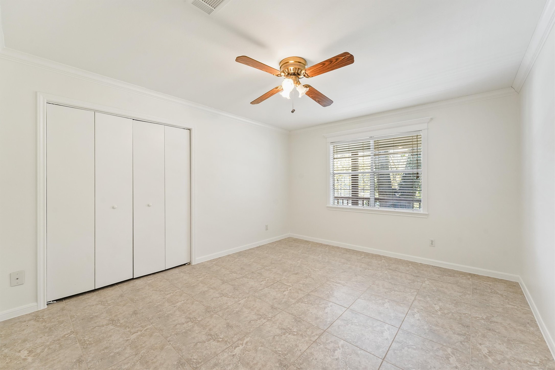 22514 Lakeway Drive Spring, TX 77373 - Photo 16 of 18 an empty room with windows and fan