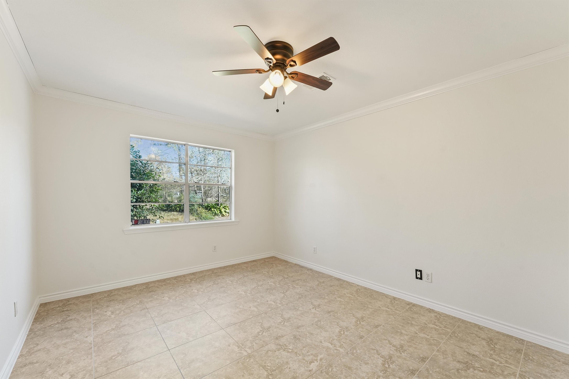 22514 Lakeway Drive Spring, TX 77373 - Photo 17 of 18 an empty room with a window and a fan