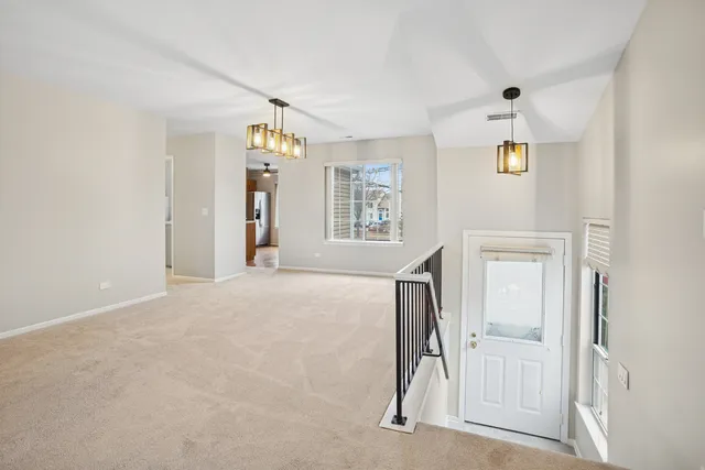 a view of a livingroom with a ceiling fan and window