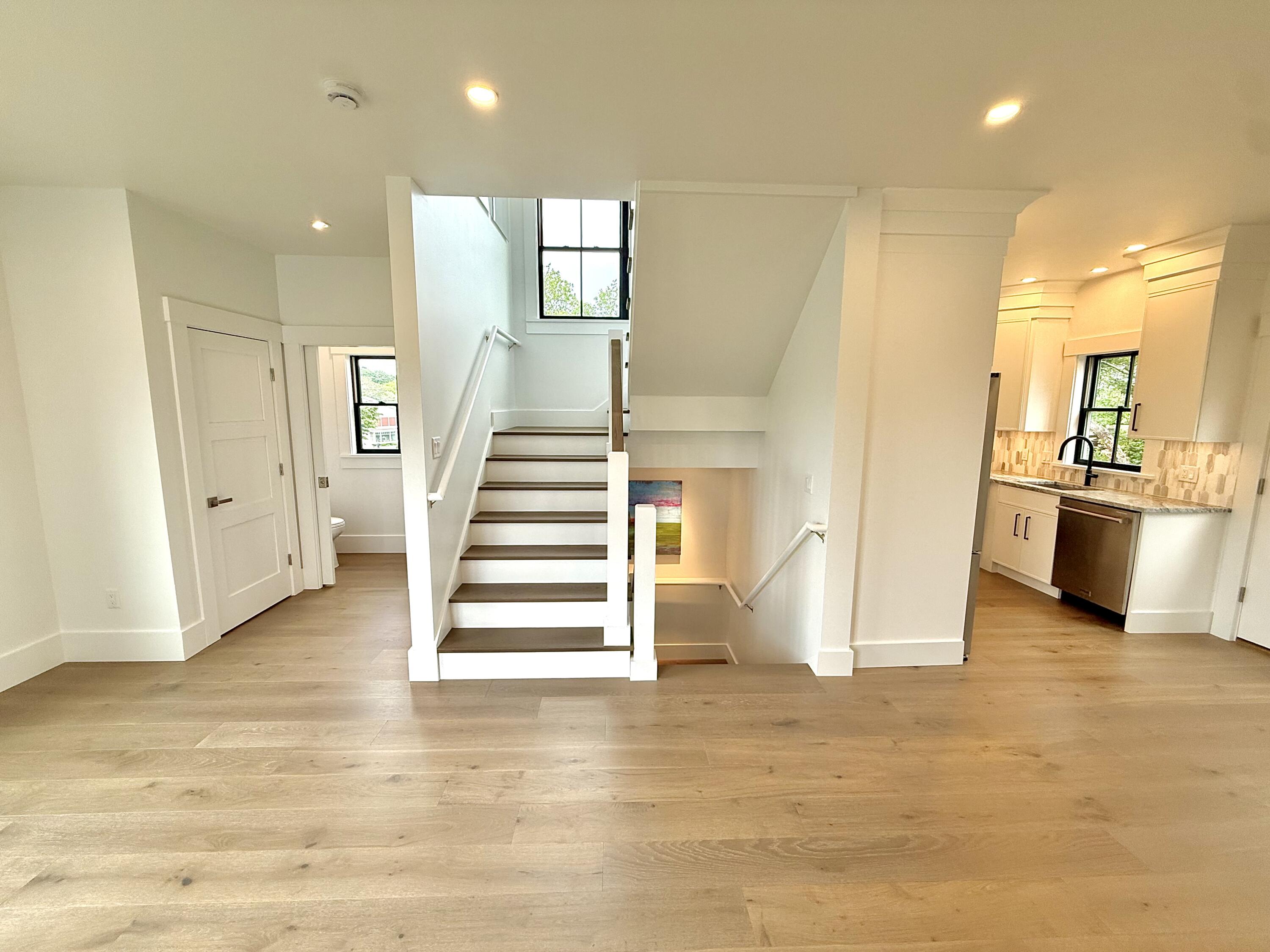 29 Cemetery Road, Unit 2 Provincetown, MA 02657 - Photo 13 of 30 a view of a kitchen with wooden floor and stairs