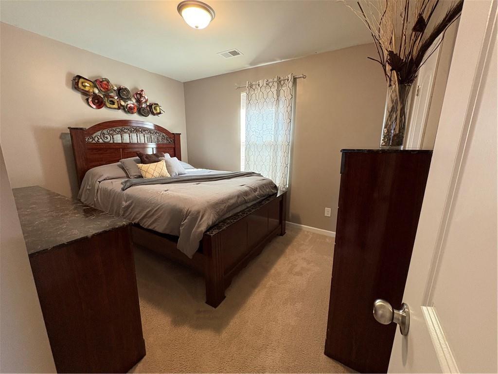 1728 Mary Avenue Griffin, GA 30224 - Photo 22 of 31 a bedroom with a bed and a mirror on the dresser