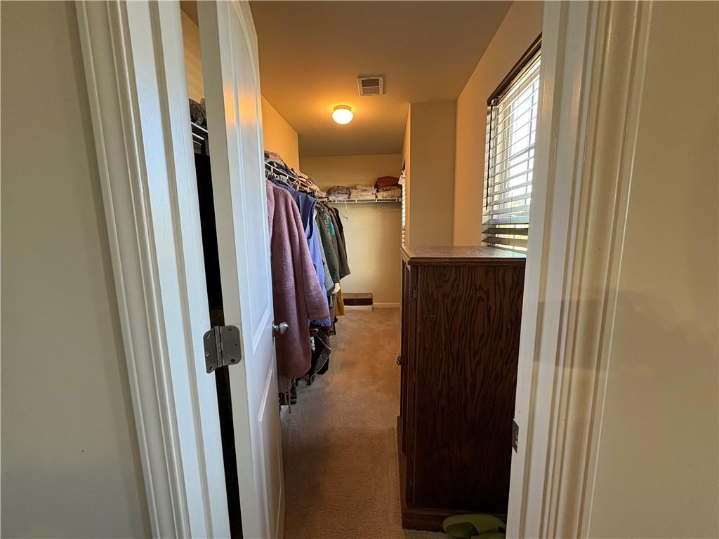 1728 Mary Avenue Griffin, GA 30224 - Photo 29 of 31 a view of walk in closet with clothes and shoes