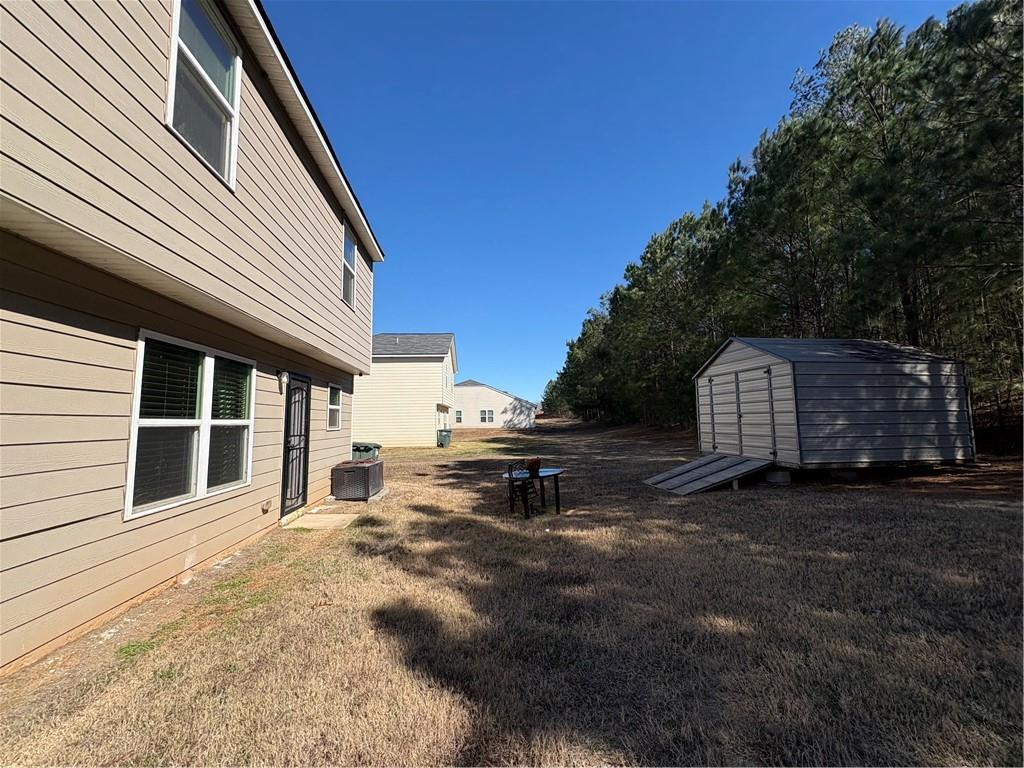 1728 Mary Avenue Griffin, GA 30224 - Photo 31 of 31 a backyard of a house with fire pit and trees