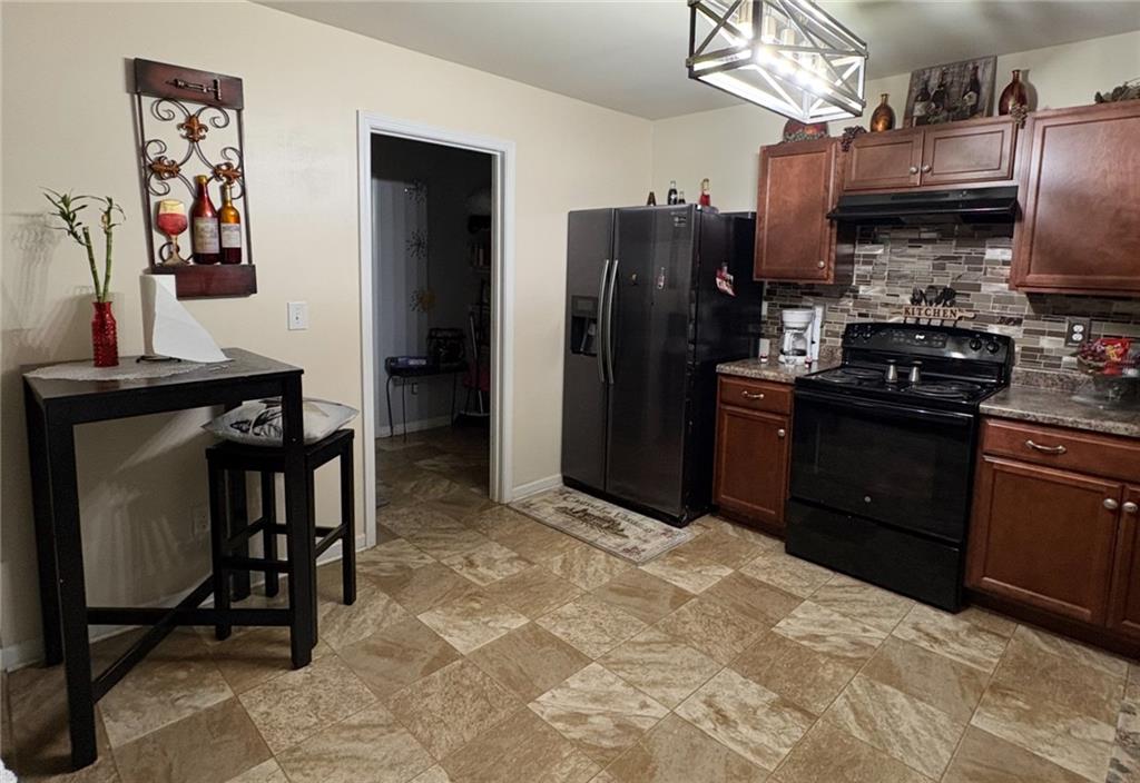1728 Mary Avenue Griffin, GA 30224 - Photo 6 of 31 a kitchen with stainless steel appliances granite countertop a refrigerator stove and sink