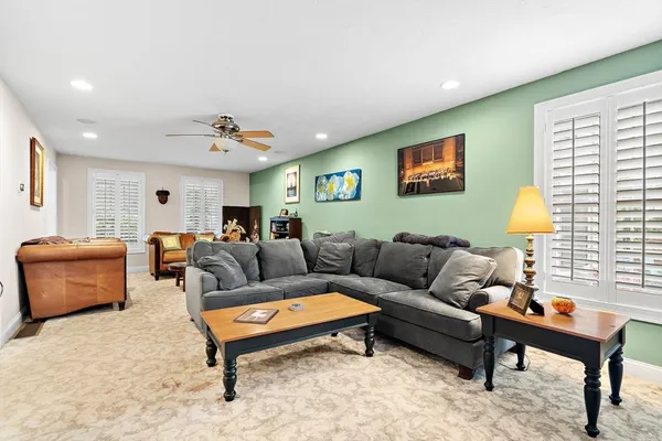 a living room with furniture a rug and a window