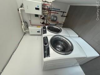 733 East Walnut Street, Unit UPPR Long Beach, NY 11561 - Photo 25 of 26 a utility room with dryer and washer