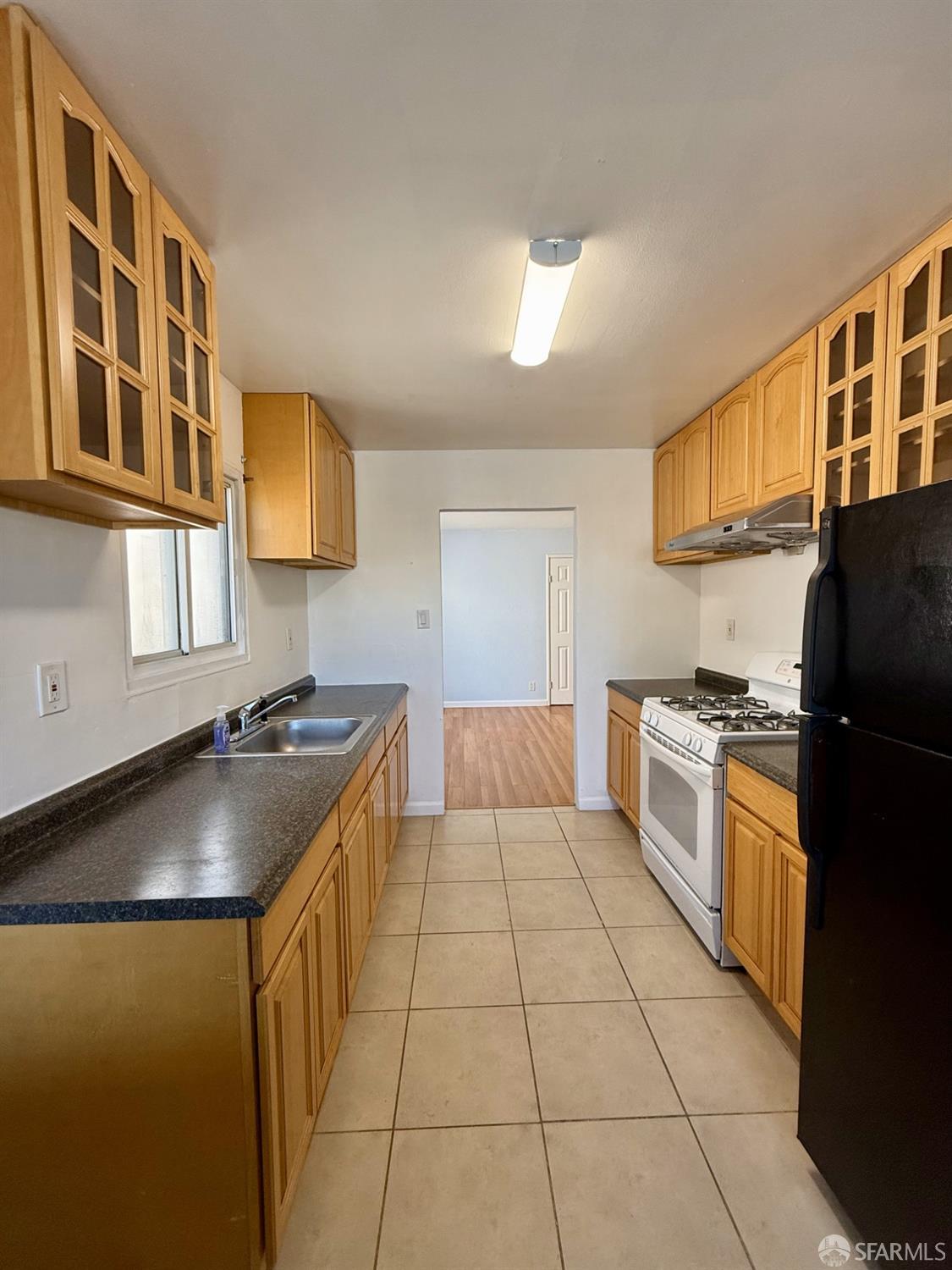 45 Spruce Street Millbrae, CA 94030 - Photo 11 of 17 a kitchen with stainless steel appliances granite countertop a sink and cabinets