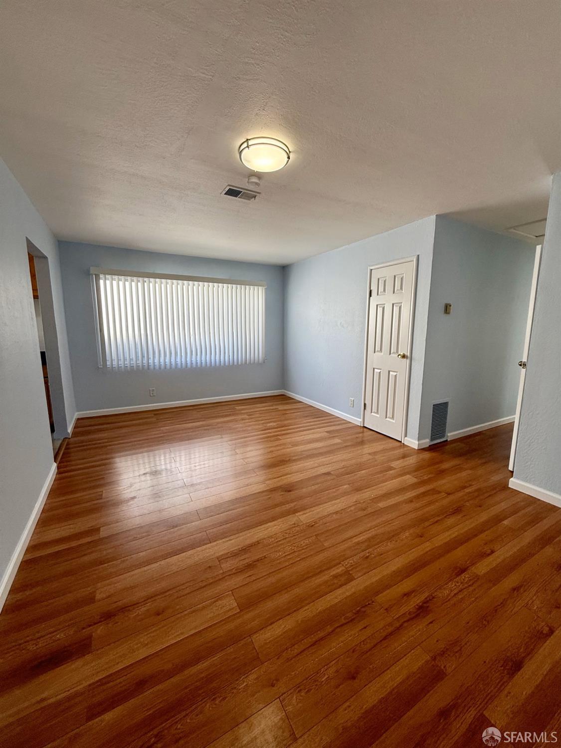 45 Spruce Street Millbrae, CA 94030 - Photo 6 of 17 a view of empty room with wooden floor and fan