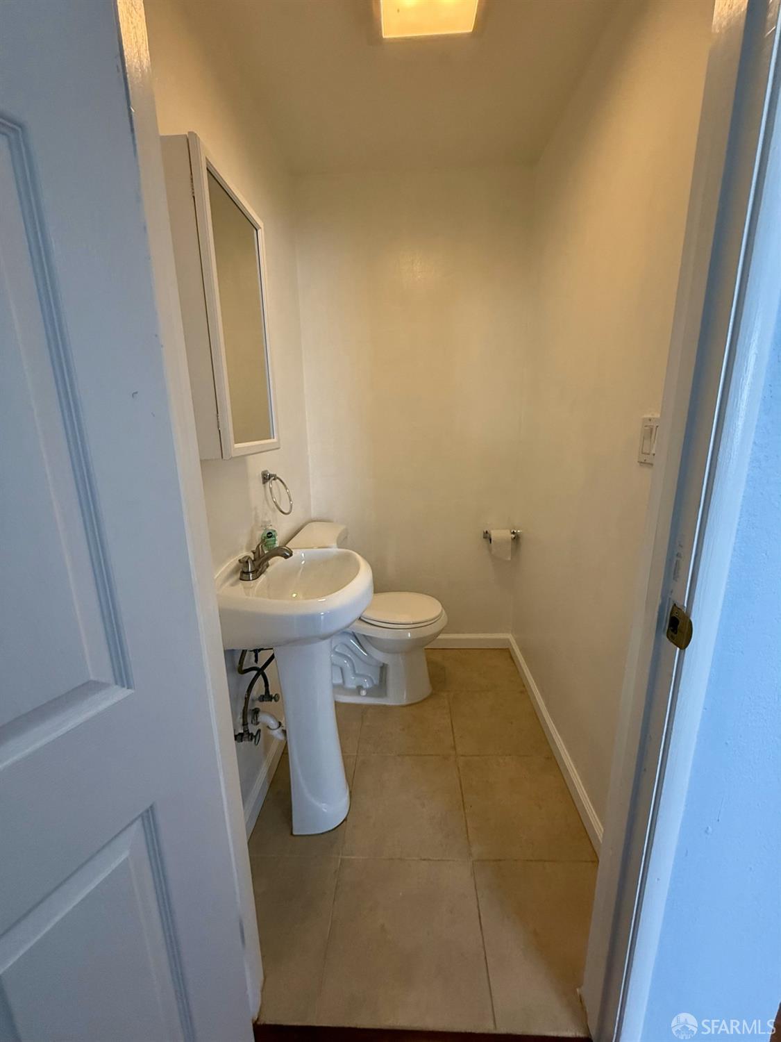 45 Spruce Street Millbrae, CA 94030 - Photo 9 of 17 a bathroom with a sink a toilet and mirror