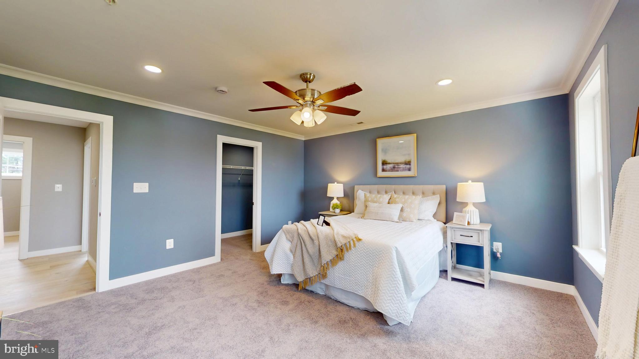 6516 Golden Ring Road Rosedale, MD 21237 - Photo 13 of 32 a bedroom with a large bed and a chandelier