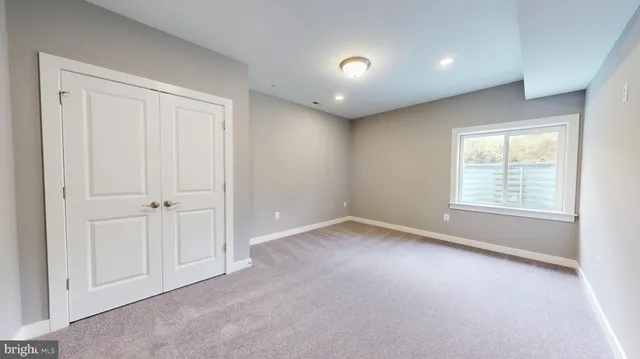 an empty room with windows and closet