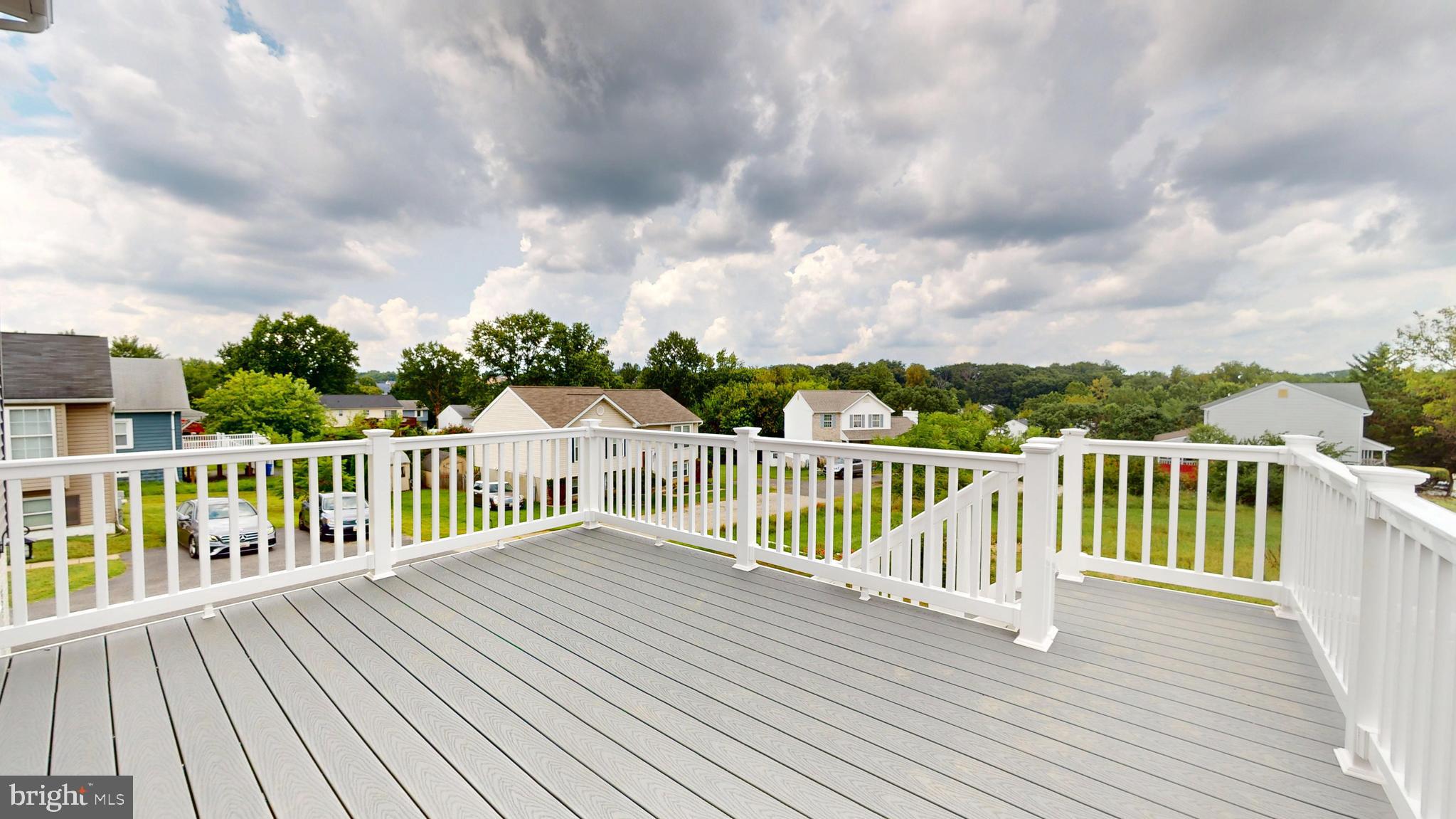 6516 Golden Ring Road Rosedale, MD 21237 - Photo 31 of 32 a balcony with wooden floor and fence