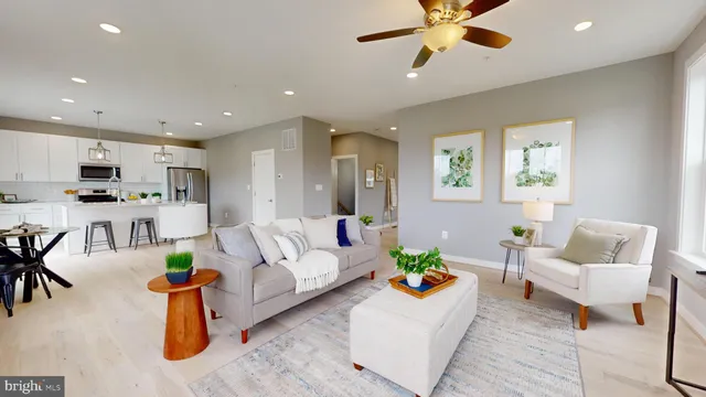 a living room with furniture and kitchen view