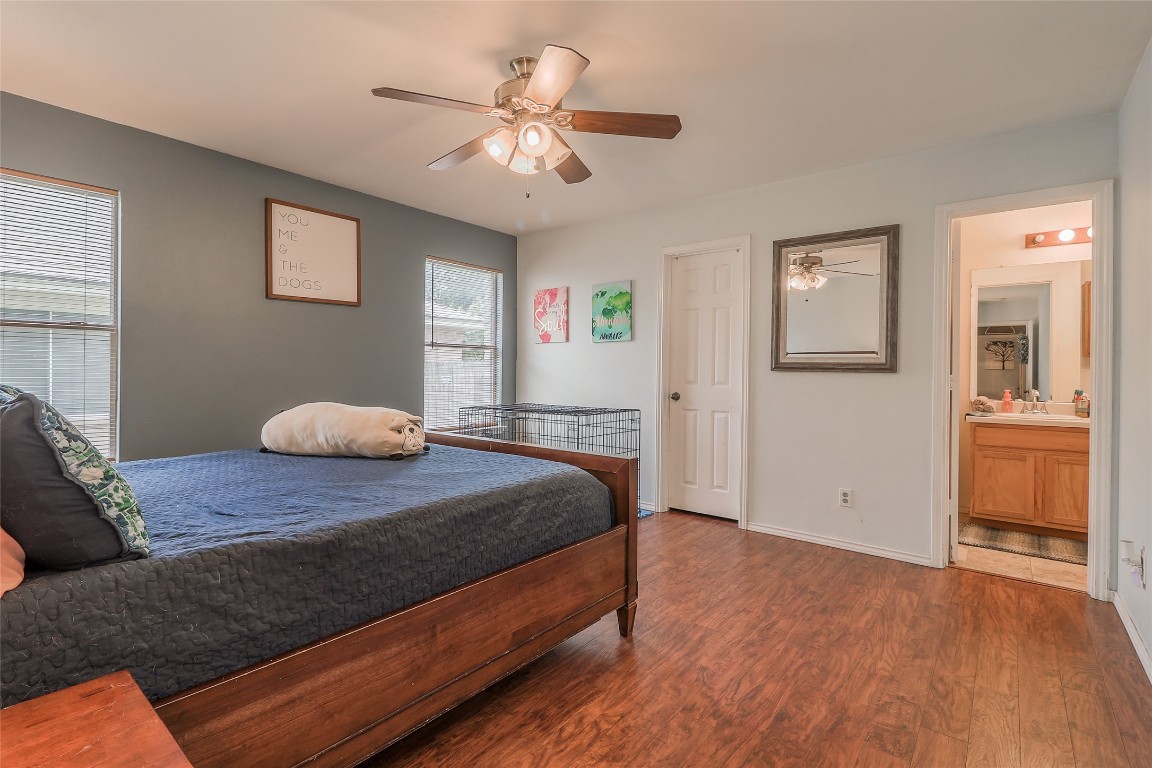 1705 Friars Tale Lane Austin, TX 78748 - Photo 12 of 29 a bedroom with a large bed and a chandelier