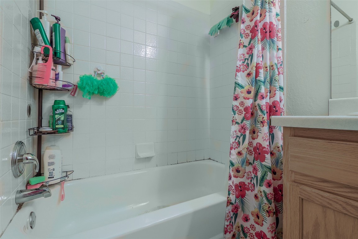 1705 Friars Tale Lane Austin, TX 78748 - Photo 15 of 29 a bathroom with a shower curtain and a bath tub