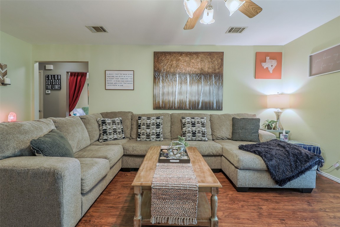 1705 Friars Tale Lane Austin, TX 78748 - Photo 6 of 29 a living room with a couch and chandelier