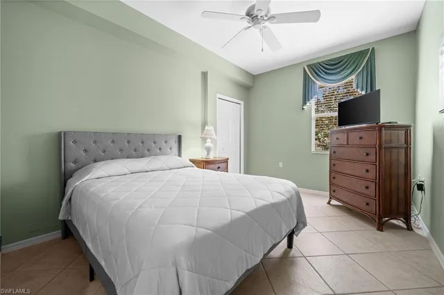 a bedroom with a bed and a mirror