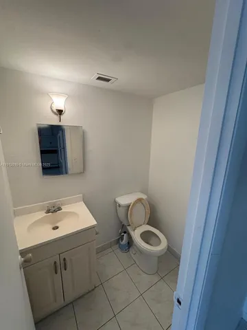 a bathroom with a sink a toilet and mirror