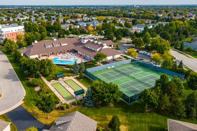 an aerial view of residential houses with outdoor space and river