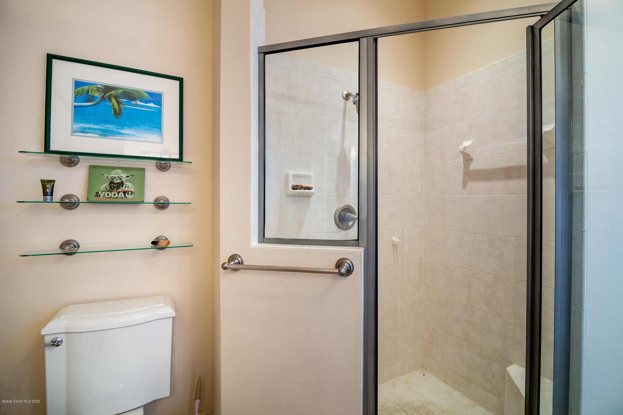 4070 Alamanda Key Drive Melbourne, FL 32901 - Photo 11 of 32 a bathroom with a shower and a toilet next to a shower