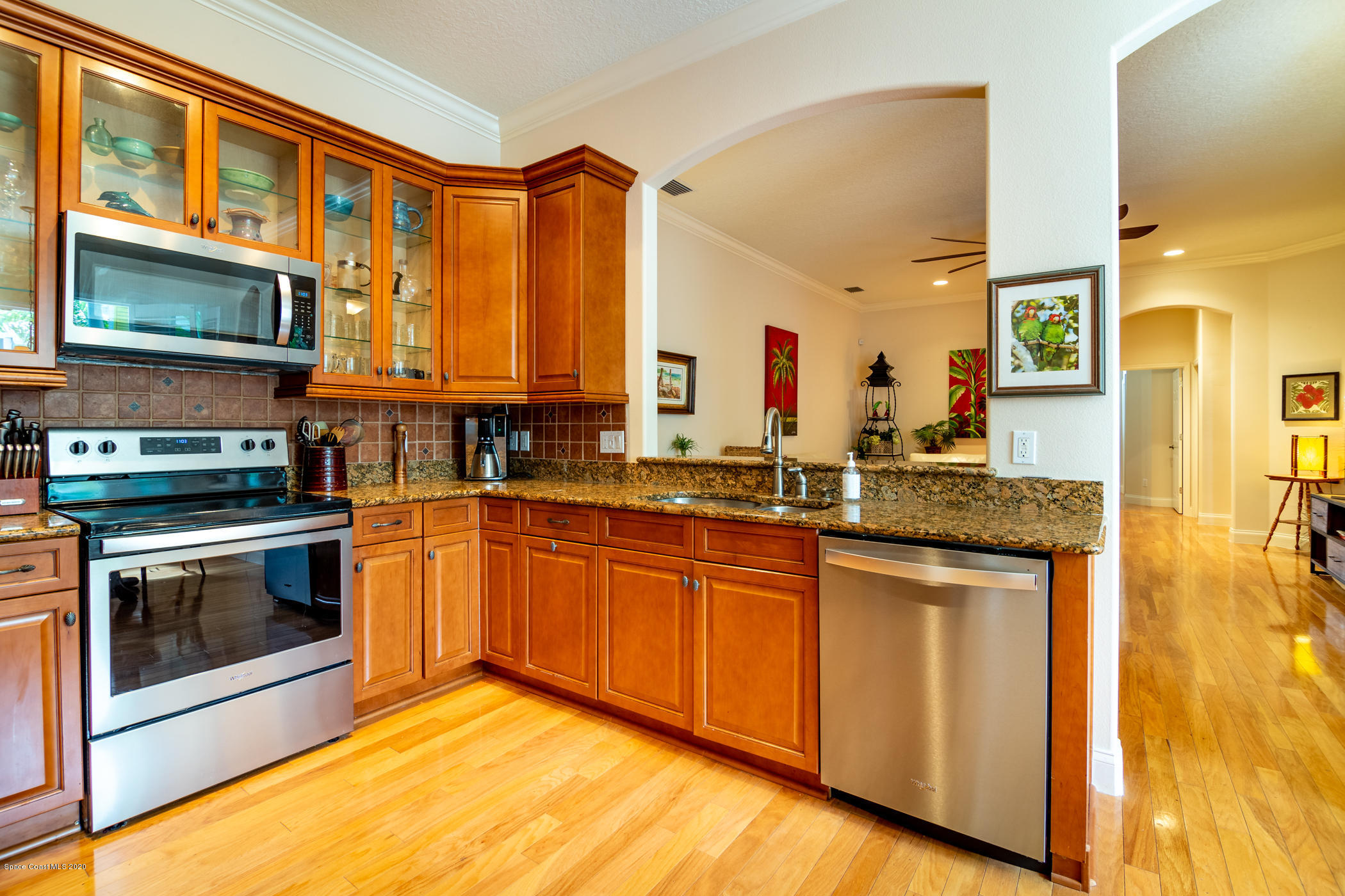 4070 Alamanda Key Drive Melbourne, FL 32901 - Photo 12 of 32 a kitchen with stainless steel appliances granite countertop a stove a sink and a microwave