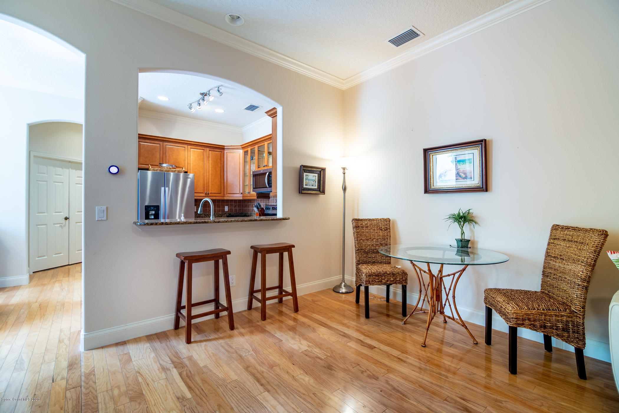 4070 Alamanda Key Drive Melbourne, FL 32901 - Photo 16 of 32 a view of a dining room with furniture and wooden floor
