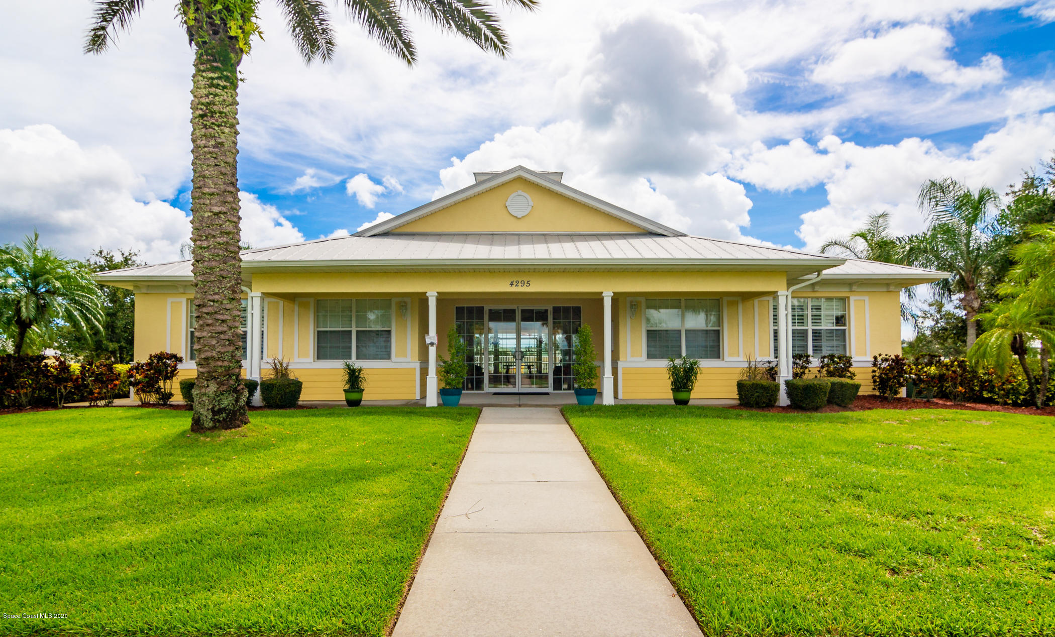 4070 Alamanda Key Drive Melbourne, FL 32901 - Photo 24 of 32 a front view of a house with a garden and patio