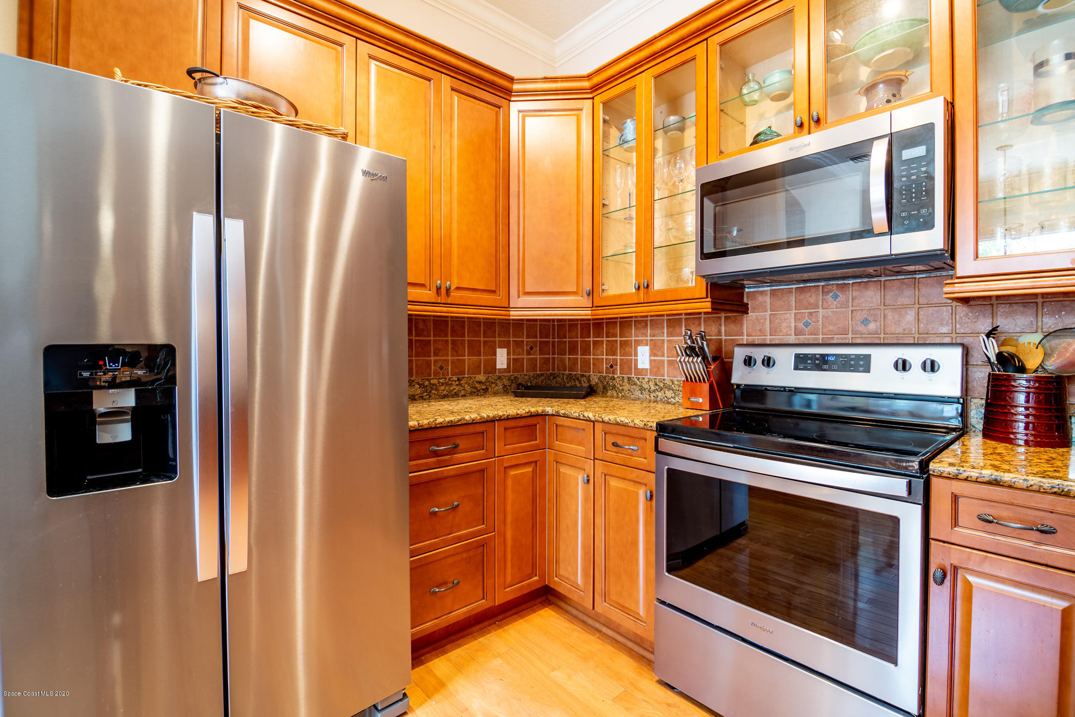 4070 Alamanda Key Drive Melbourne, FL 32901 - Photo 10 of 32 a kitchen with stainless steel appliances granite countertop a refrigerator a stove and a microwave