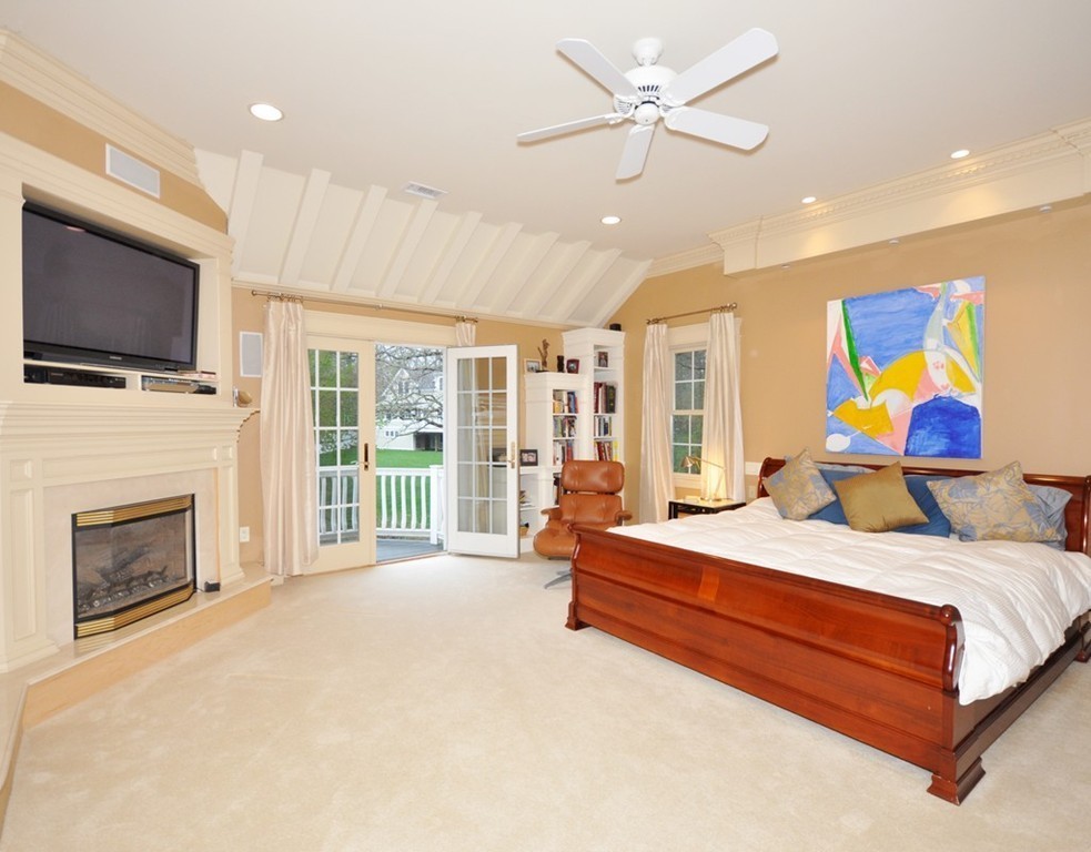 65 Summit Street Concord, MA 01742 - Photo 20 of 29 a bedroom with a bed flat screen tv and a fireplace