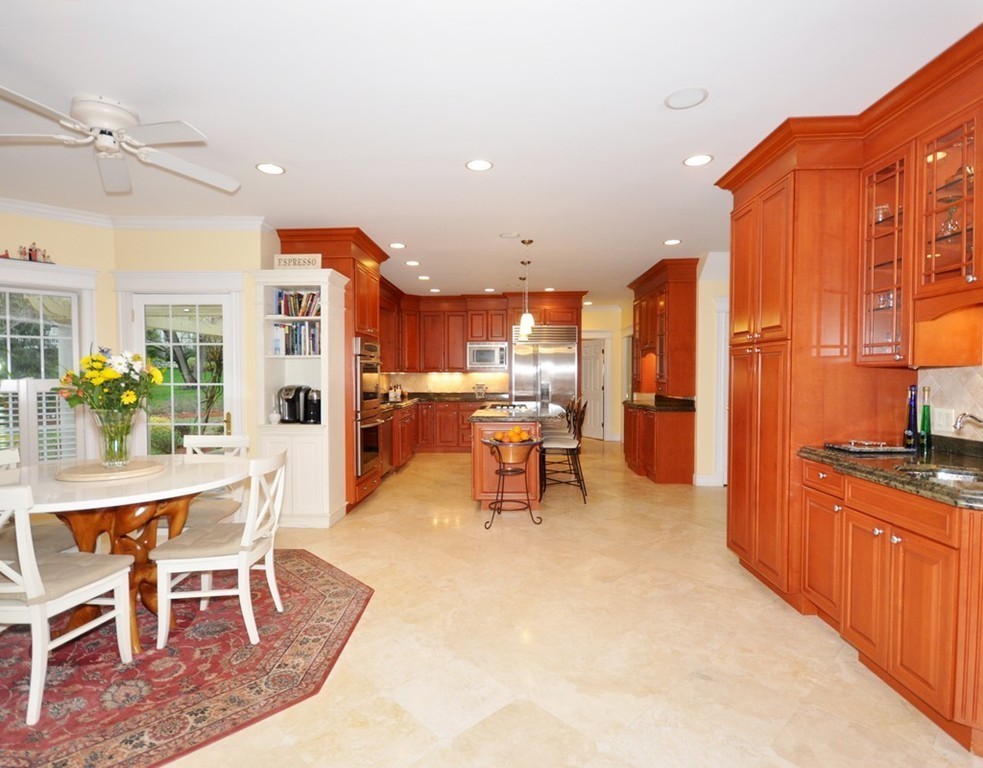 65 Summit Street Concord, MA 01742 - Photo 3 of 29 a kitchen with stainless steel appliances kitchen island granite countertop a refrigerator and chairs
