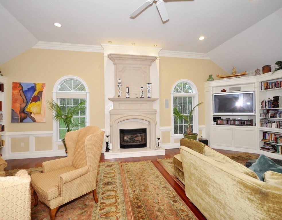 65 Summit Street Concord, MA 01742 - Photo 10 of 29 a living room with furniture a flat screen tv and a fireplace