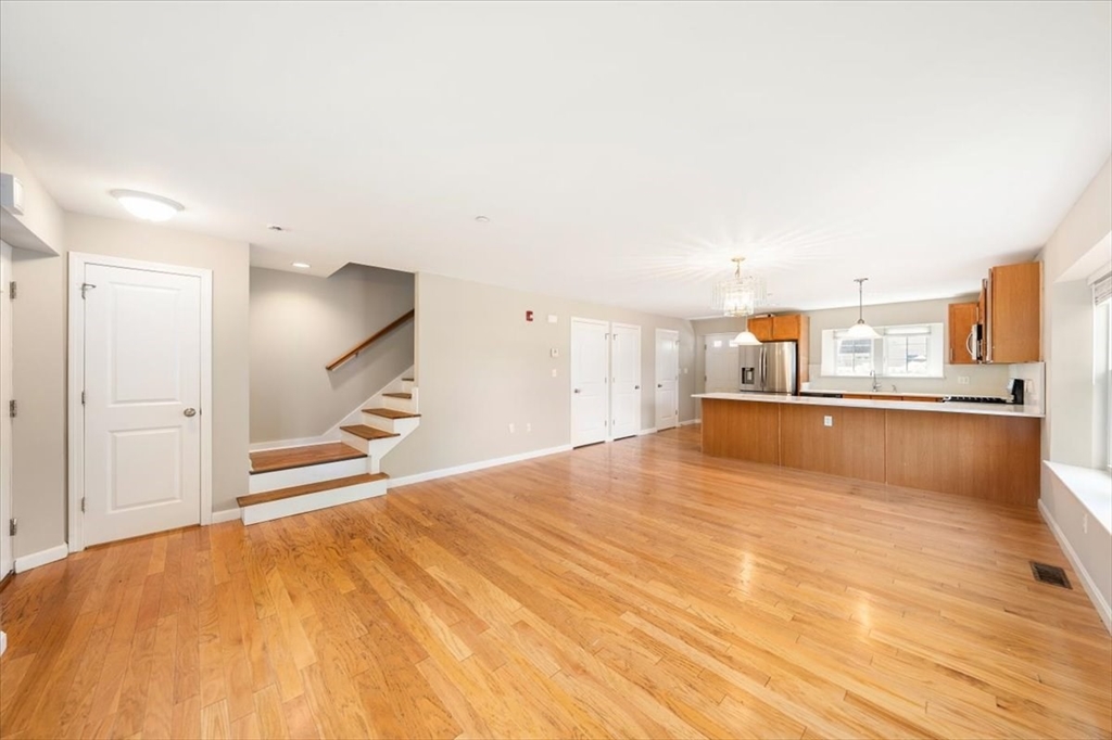 6 Bates Street, Unit A Devens, MA 01434 - Photo 6 of 41 a view of kitchen and empty room with wooden floor