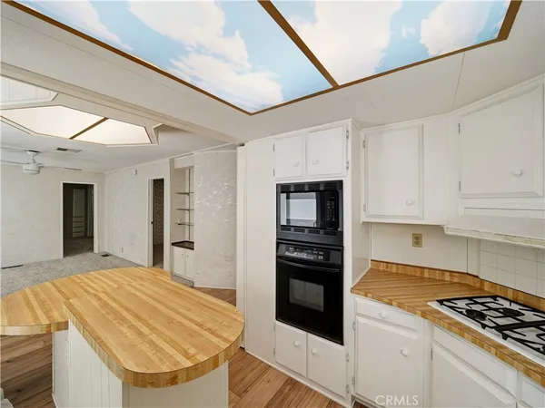 a kitchen with stainless steel appliances kitchen island granite countertop a stove and a refrigerator