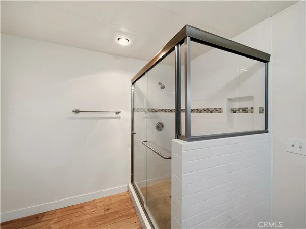 a bathroom with a shower and a glass door
