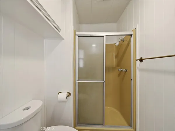 a bathroom with a shower and toilet